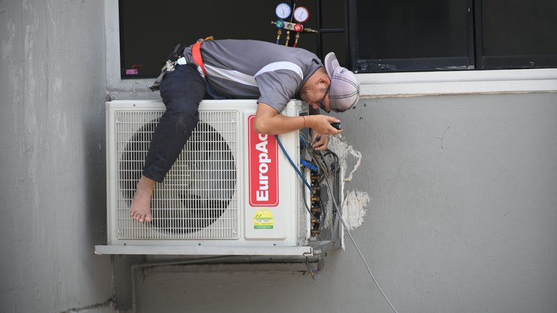 An air conditioning unit being serviced
