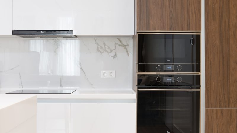 A modern kitchen with a built-in microwave